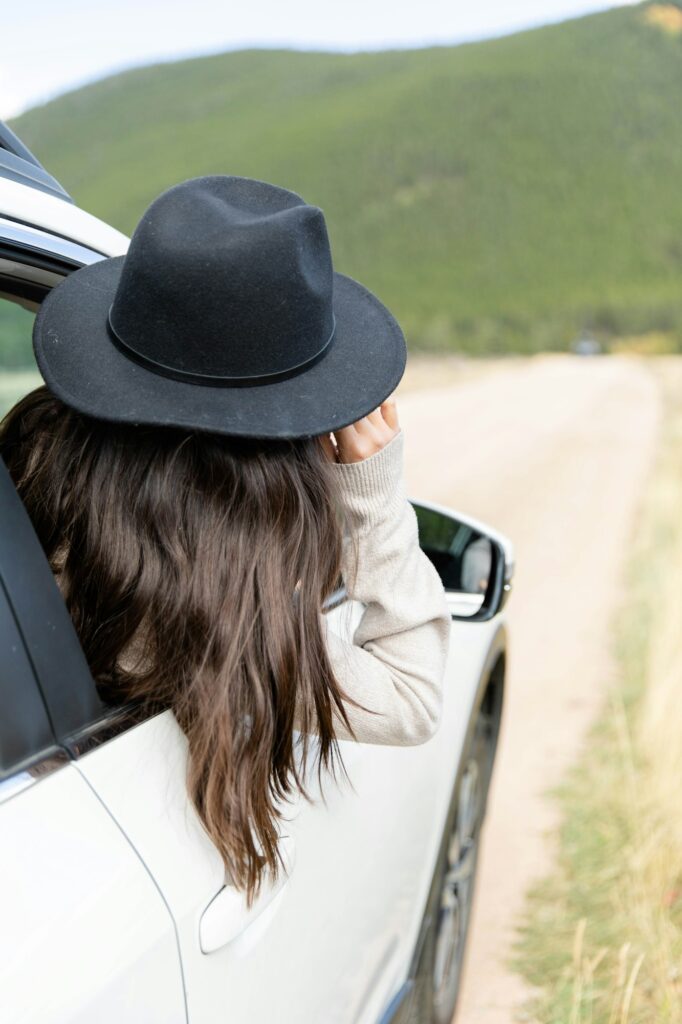 Young woman looking out the passenger side window on a road-trip